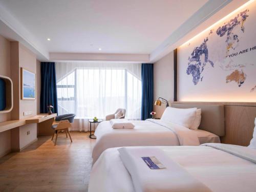 Imagen de la habitación del Hotel Kyriad Marvelous Heyuan Wanda Plaza. Foto 17