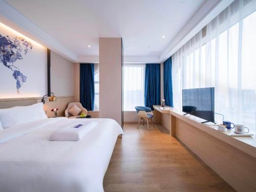 Imagen de la habitación del Hotel Kyriad Marvelous Heyuan Wanda Plaza. Foto 20
