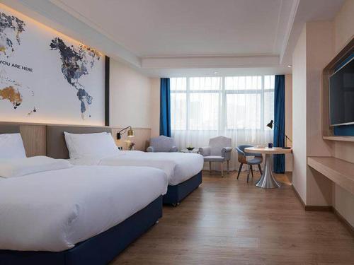Imagen de la habitación del Hotel Kyriad Marvelous Heyuan Wanlong City. Foto 9