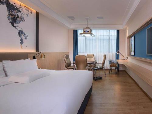 Imagen de la habitación del Hotel Kyriad Marvelous Heyuan Wanlong City. Foto 10