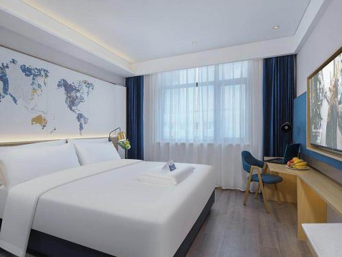 Imagen de la habitación del Hotel Kyriad Marvelous Weihai Happy Gate Weigao Plaza. Foto 15