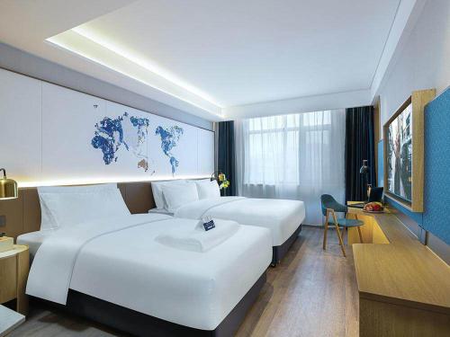 Imagen de la habitación del Hotel Kyriad Marvelous Weihai Happy Gate Weigao Plaza. Foto 16