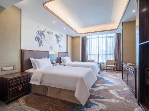 Imagen de la habitación del Hotel Kyriad Marvelous Weihai Railway Station. Foto 13