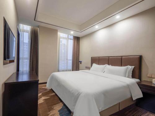 Imagen de la habitación del Hotel Kyriad Marvelous Weihai Railway Station. Foto 14