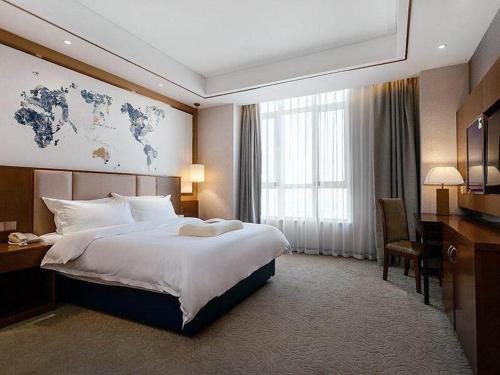 Imagen de la habitación del Hotel Kyriad Marvelous Weihai Railway Station. Foto 17