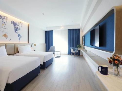 Imagen de la habitación del Hotel Kyriad Shenzhen Pingdi Low Carbon City. Foto 19