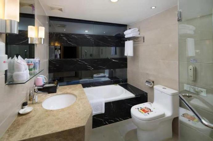 Imagen de la habitación del Hotel LOTUS HUATIAN HOTEL. Foto 7