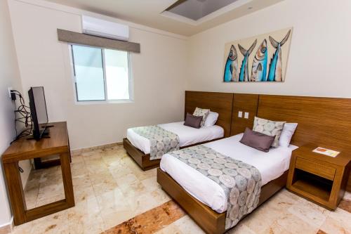 Imagen de la habitación del Hotel La Palma Beachfront and Club Nautico. Foto 5