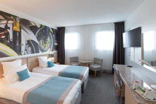 Imagen de la habitación del Hotel Le Paddock. Foto 10