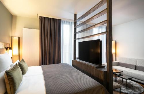 Imagen de la habitación del Hotel Leonardo Royal Munich. Foto 18