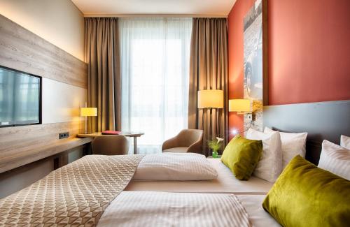 Imagen de la habitación del Hotel Leonardo Wolfsburg City Center. Foto 16