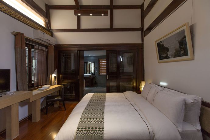Imagen de la habitación del Hotel Lijiang Junpoxuan. Foto 6