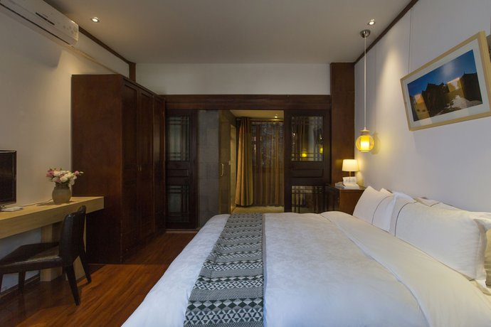 Imagen de la habitación del Hotel Lijiang Junpoxuan. Foto 14