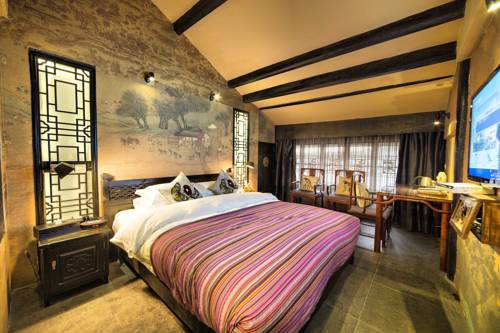 Imagen de la habitación del Hotel Lijiang Ten Courtyard Inn. Foto 1