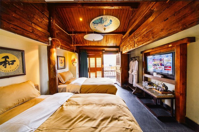 Imagen de la habitación del Hotel Lijiang Wengjia Dayuan. Foto 18