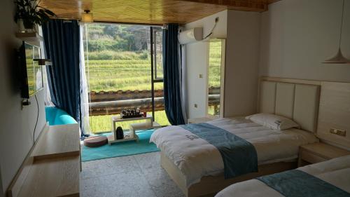 Imagen general del Hotel Longsheng Longji Puchuo Shengxiang Art. Foto 1