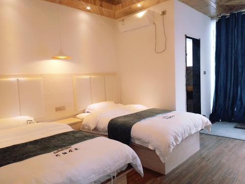 Imagen de la habitación del Hotel Longsheng Longji Puchuo Shengxiang Art. Foto 9