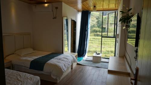 Imagen de la habitación del Hotel Longsheng Longji Puchuo Shengxiang Art. Foto 10