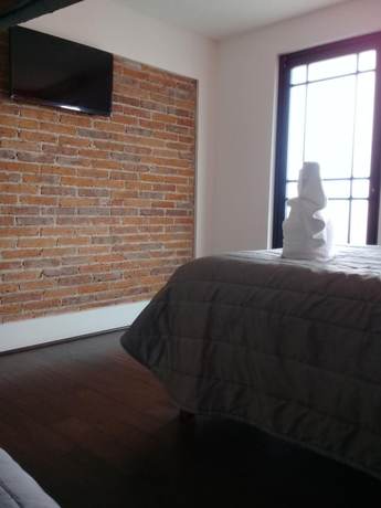 Imagen de la habitación del Hotel MH. Foto 11