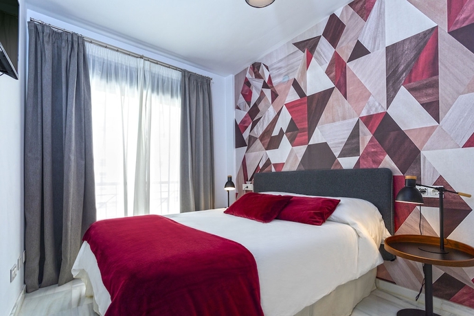 Imagen de la habitación del Hotel M&aacute;laga Rivas 34 Suites Homes. Foto 10