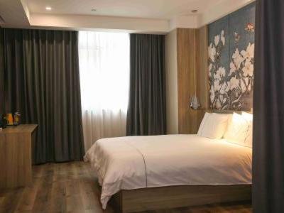 Imagen de la habitación del Hotel Magnolia Business Yangzhou Wanda Plaza Shunda Road. Foto 20