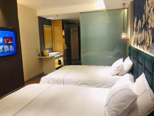 Imagen de la habitación del Hotel Magnotel YangZhou China Grand Canal Museum Wanda Plaza. Foto 18