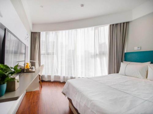 Imagen de la habitación del Hotel Magnotel Yangzhou Jinghua Wangyue Road. Foto 20