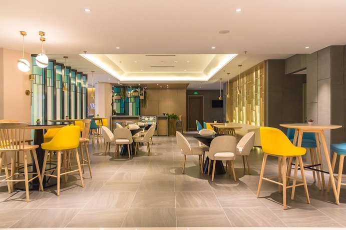 Imagen del bar/restaurante del Hotel Magnotel the city government huludao. Foto 4