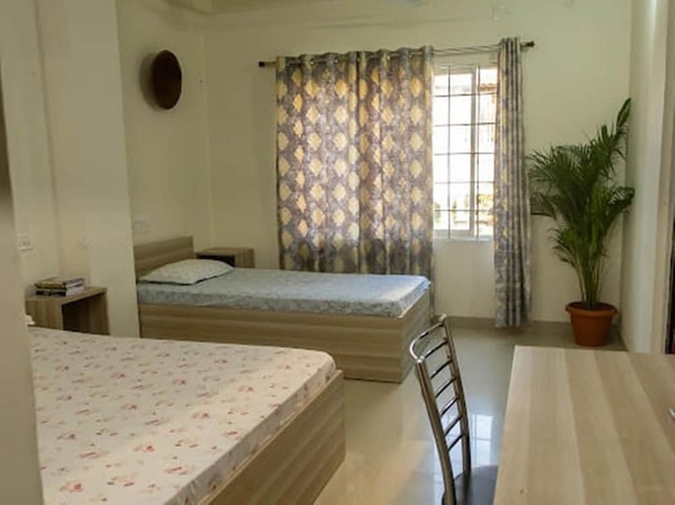 Imagen de la habitación del Hotel Malini Homes - Food and Lodging. Foto 6