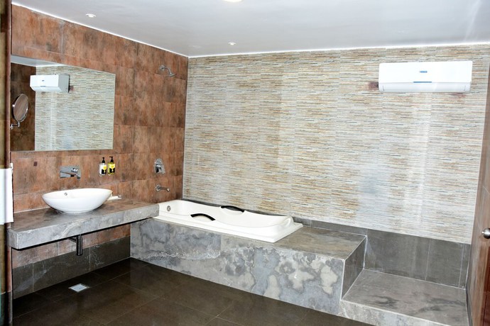 Imagen de la habitación del Hotel Mangos Haridwar. Foto 15