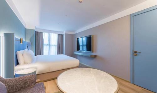 Imagen de la habitación del Hotel Manxin Guangzhou Baiyun Airport Branch. Foto 20