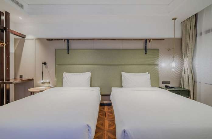 Imagen de la habitación del Hotel Manxin Qingdao Zhanqiao. Foto 11