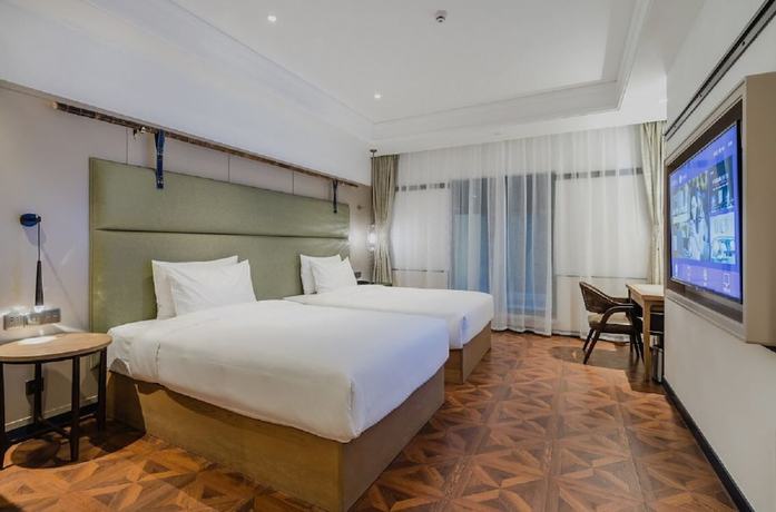Imagen de la habitación del Hotel Manxin Qingdao Zhanqiao. Foto 13