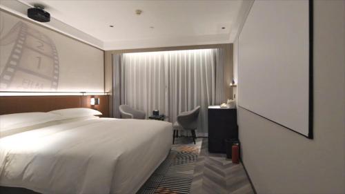 Imagen de la habitación del Hotel Mehood Guangzhou Pazhou Convention and Exhibition Center. Foto 12