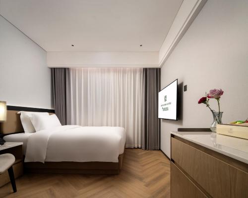 Imagen de la habitación del Hotel Mehood Lestie Panyu Wanbo Yuangang Metro Station Branch - Free Shuttle Bus to Canton Fair Comp. Foto 16