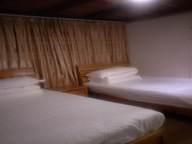 Imagen de la habitación del Hotel Nanjing Tulou Qingdelou Inn. Foto 11