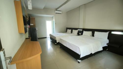 Imagen de la habitación del Hotel New Bandengan Beach. Foto 19