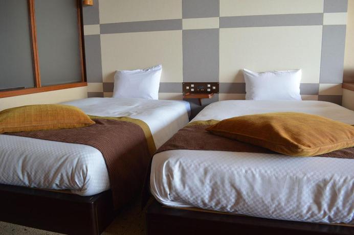 Imagen de la habitación del Hotel New Kankai Honkan Tenku Hotel Kairo. Foto 14