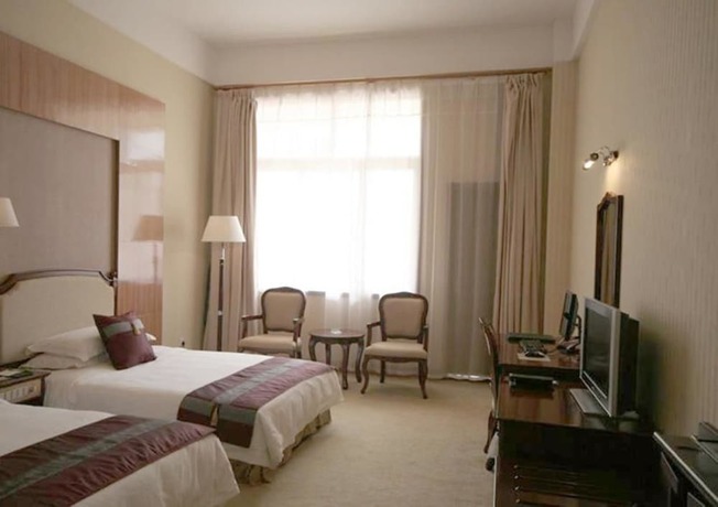 Imagen de la habitación del Hotel New Tai Garden Hotel. Foto 3