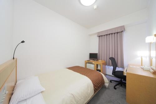 Imagen de la habitación del Hotel New Tanaka. Foto 8