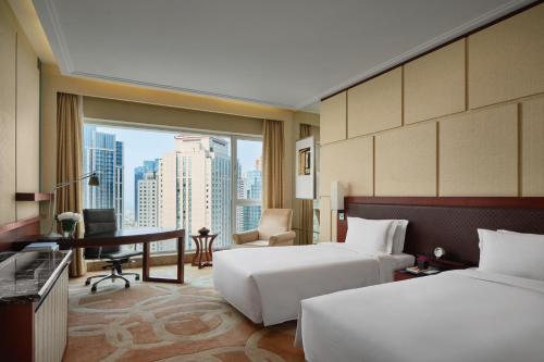 Imagen de la habitación del Hotel New World Dalian. Foto 3