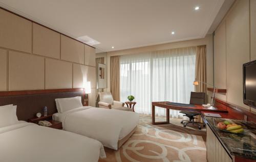 Imagen de la habitación del Hotel New World Dalian. Foto 5