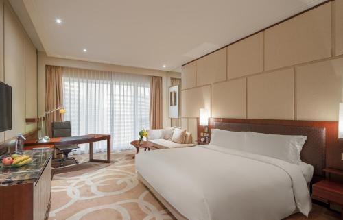 Imagen de la habitación del Hotel New World Dalian. Foto 6