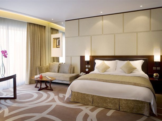 Imagen de la habitación del Hotel New World Dalian. Foto 7