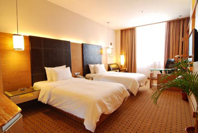 Imagen de la habitación del Hotel New World Suites. Foto 9