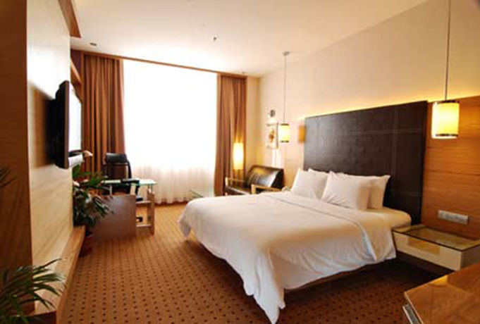 Imagen de la habitación del Hotel New World Suites. Foto 11