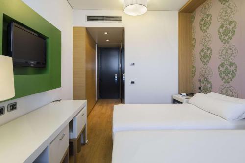 Imagen de la habitación del Hotel Nh Milano Fiera. Foto 18