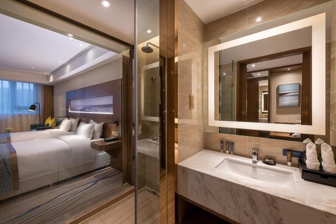 Imagen de la habitación del Hotel Novotel Qingdao New Hope. Foto 11