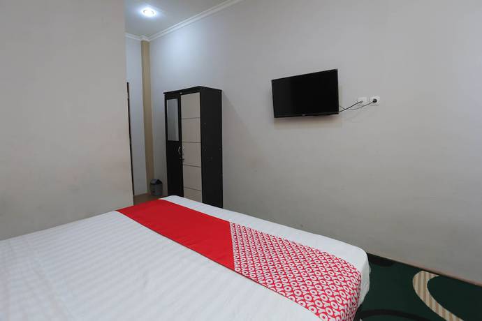 Imagen de la habitación del Hotel OYO 1864 Tiara Guest House. Foto 12