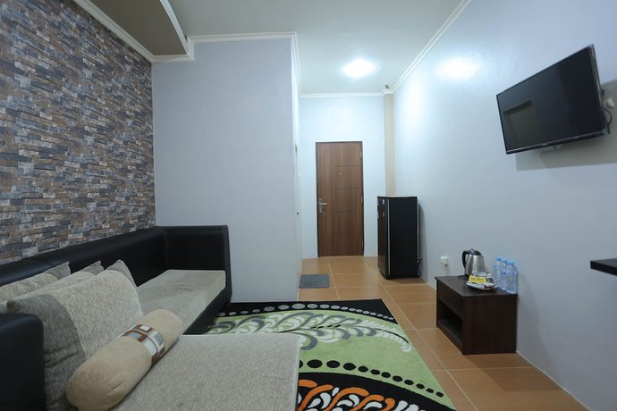 Imagen de la habitación del Hotel OYO 1864 Tiara Guest House. Foto 14